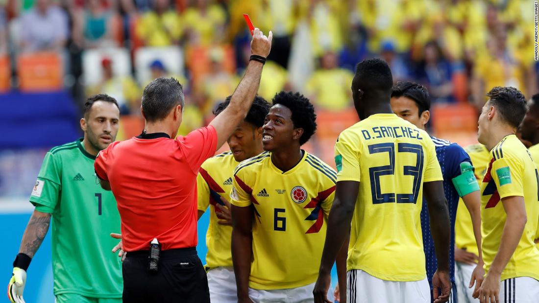 The referee shows a red card to Colombia&#39;s Carlos Sanchez in the third minute. Sanchez was deemed to have deliberately handled the ball in the box.