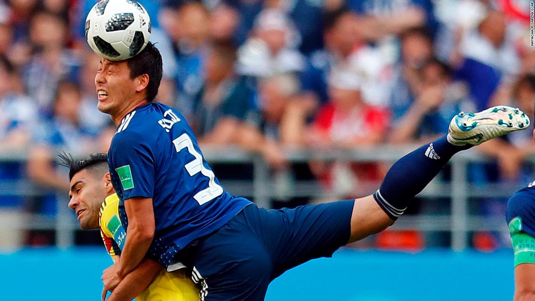 Japanese defender Gen Shoji climbs over Colombia&#39;s Radamel Falcao to win a header in their World Cup opener on June 19. Japan won the match 2-1.