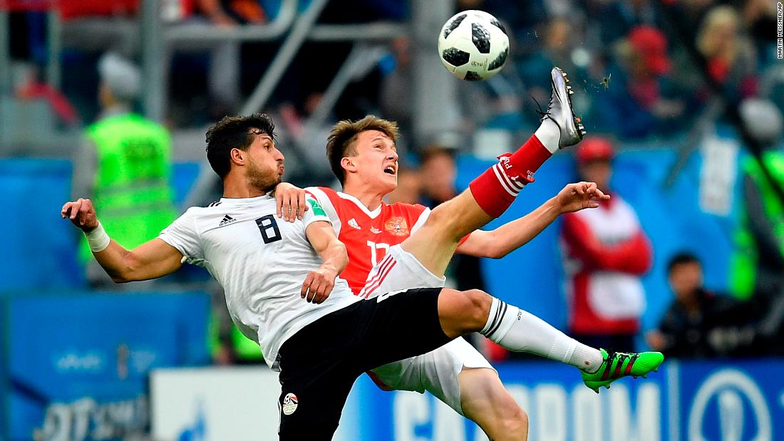 Egypt&#39;s Tarek Hamed, left, and Russia&#39;s Aleksandr Golovin compete for the ball.