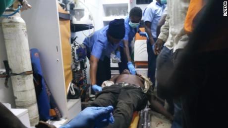 Rescue teams attending to one of those wounded at the scene of the accident in Lagos, Nigeria  on Tuesday.