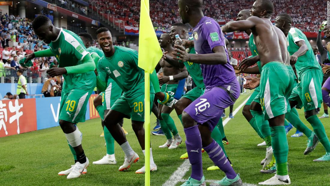 Members of the Senegal team celebrate after defeating Poland 2-1 in their match on June 19.