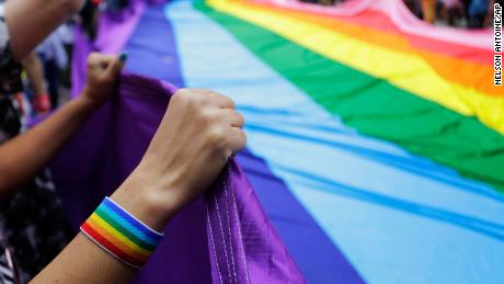 Revelers at a Pride parade hold up a giant rainbow flag in Sao Paulo, Brazil, on June 3, 2018. 