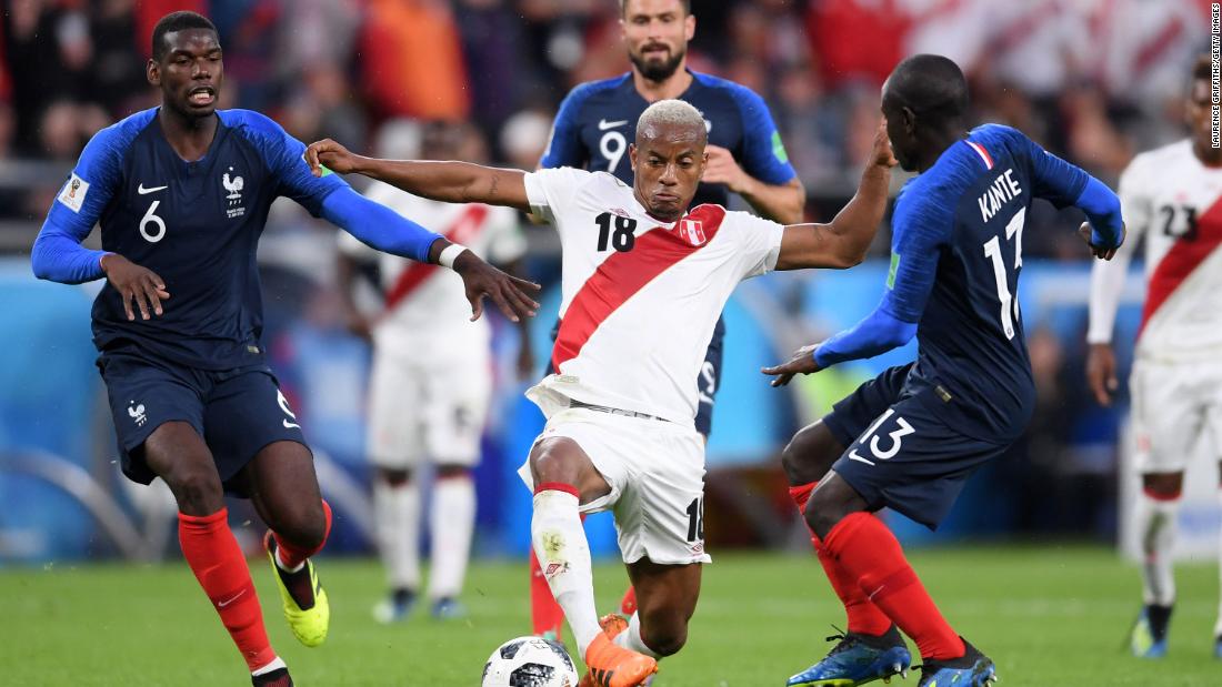 Peru&#39;s Andre Carrillo is challenged by French players Paul Pogba, left, and N&#39;Golo Kante.