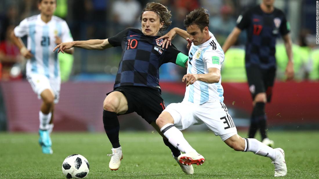 Croatia&#39;s Luka Modric is tackled by Argentina&#39;s Nicolas Tagliafico.