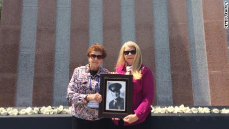 Rosanne Seydel and Ruth Hebert hold the portrait of First Lieutenant Karle Seydel, who was killed on December 7, 1950 during the Korean War.