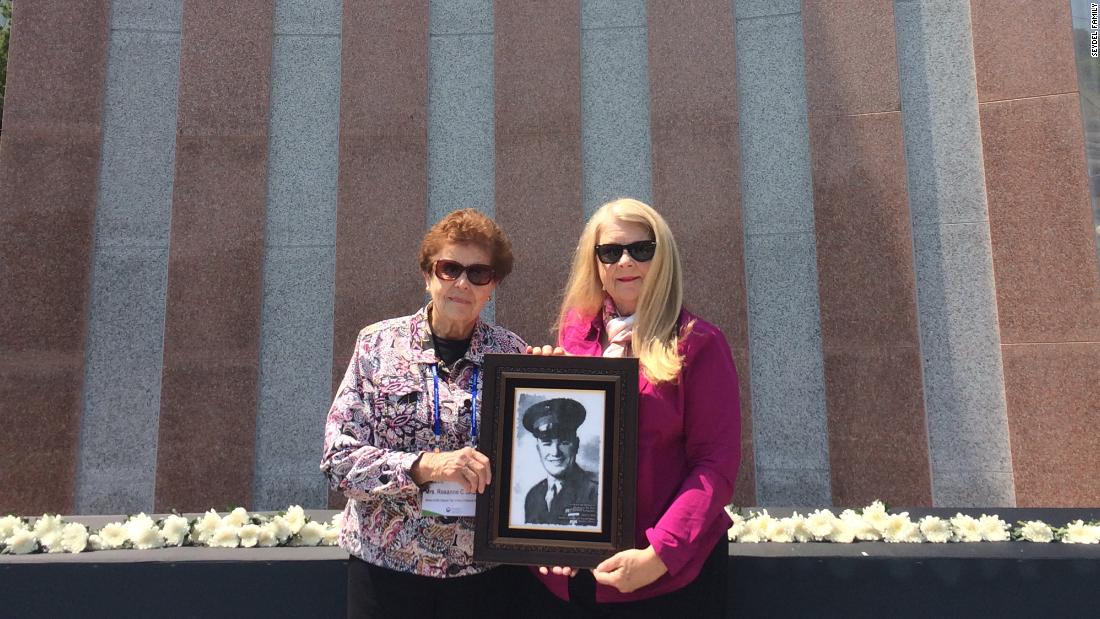 Rosanne Seydel and Ruth Hebert hold the portrait of First Lieutenant Karle Seydel, who was killed on December 7, 1950 during the Korean War.