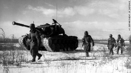 A column of troops and armor of the 1st Marine Division move through communist Chinese lines during their successful breakout from the Chosin Reservoir in North Korea. The Marines were besieged when the Chinese entered the Korean War Nov. 27, 1950, by sending 200,000 shock troops against Allied forces.