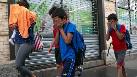 Groups of children being dropped off at Manhattan foster care agency, which Mayor Bill de Blasio says houses more than 200 migrant children. It&#39;s unclear whether the children in the photo, who cover their faces, are among those separated from their parents. 