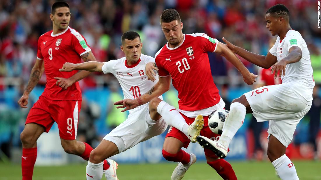 Swiss players defend Serbia&#39;s Sergej Milinkovic-Savic.