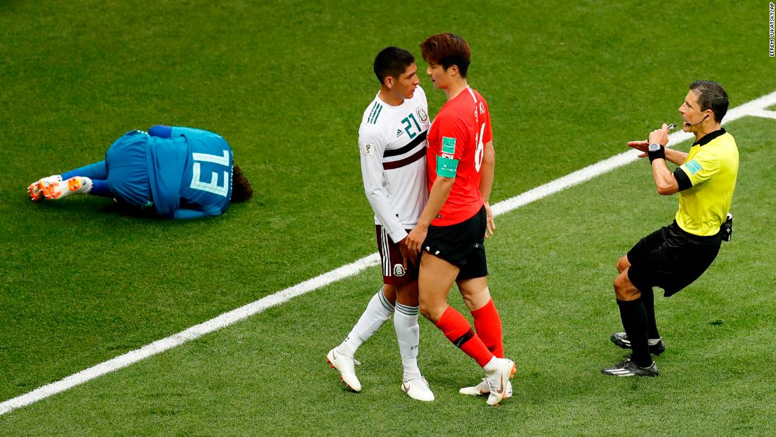 South Korea&#39;s Ki Sung-yueng, right, argues with Mexico&#39;s Edson Alvarez as Mexican goalkeeper Guillermo Ochoa lies on the ground on June 23. Mexico won 2-1.