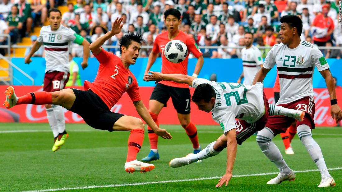 South Korea&#39;s Lee Yong, left, duels for the ball with Mexico&#39;s Hirving Lozano.