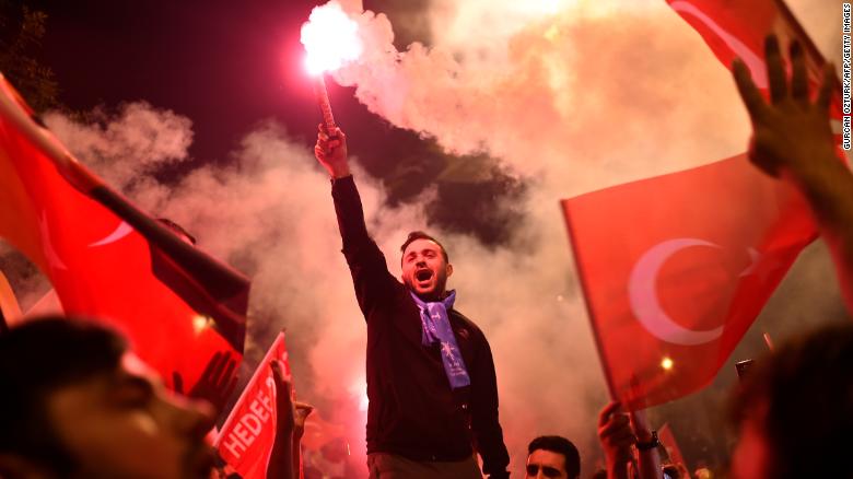 People shout slogans and let off flares after counting of votes in Turkey&#39;s presidential and parliamentary elections commenced. 