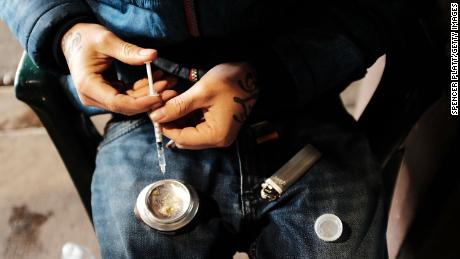  A man uses heroin under a bridge where he lives with other addicts in the Kensington section of Philadelphia which has become a hub for heroin use.