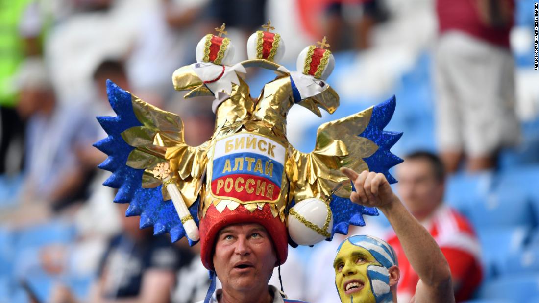 A Uruguay fan, right, poses with a Russia fan before the match.