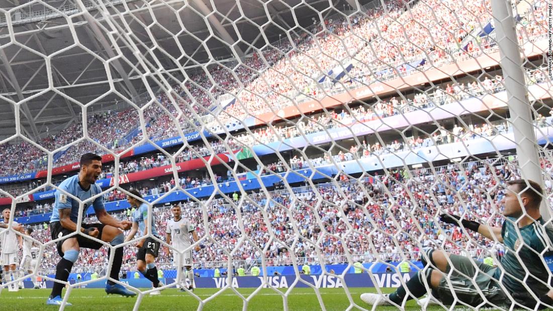 Uruguayan forward Luis Suarez, left, reacts after the second goal deflected past Russian goalkeeper Igor Akinfeev. 