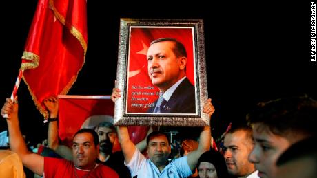 Supporters of Turkey&#39;s President Recep Tayyip Erdogan listen as he addresses them outside his official residence in Istanbul, Sunday, June 24, 2018. Erdogan has claimed victory in critical elections based on unofficial results, securing an executive presidency with sweeping powers. (AP Photo/Lefteris Pitarakis)