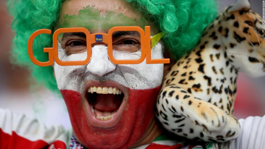 An Iran fan enjoys the pre-match atmosphere.