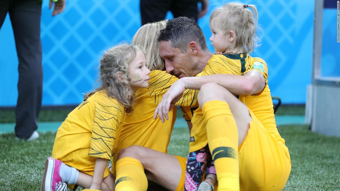 Australian player Mark Milligan is joined by his children after a 2-0 loss to Peru on June 26.