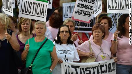 Demonstrators holding placards reading &quot;Justice&quot; outside the court Tuesday. 