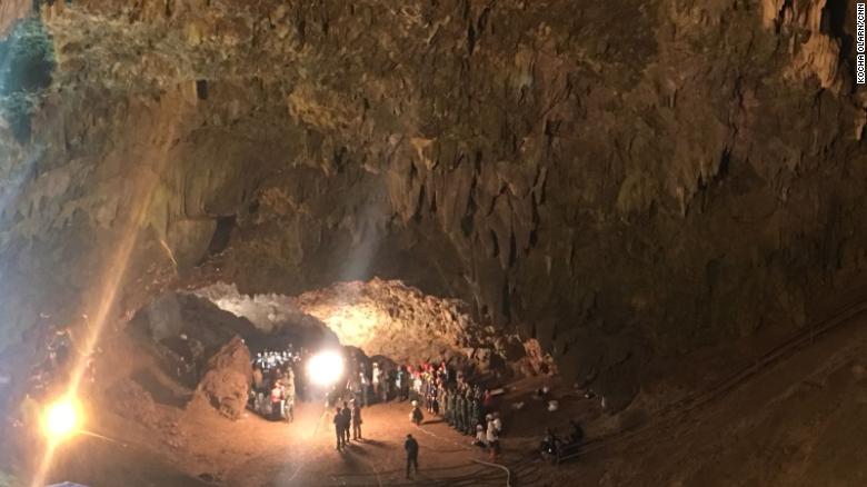 Local volunteers join members of the Thai SEAL team at the entrance to the cave network.