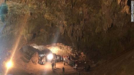 Local volunteers join members of the Thai SEAL team at the entrance to the cave network.