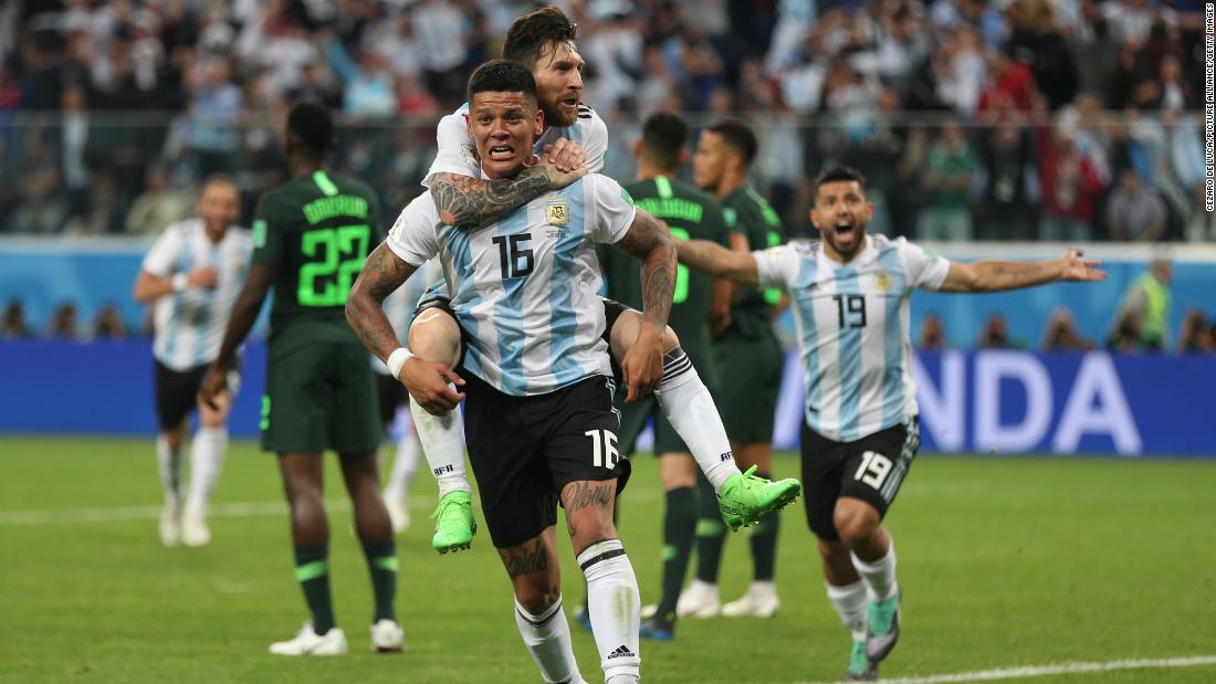 Argentina star Lionel Messi rides on the back of Marcos Rojo after Rojo&#39;s late winner against Nigeria on June 26. With the 2-1 victory, Argentina clinched a spot in the next round of the tournament.