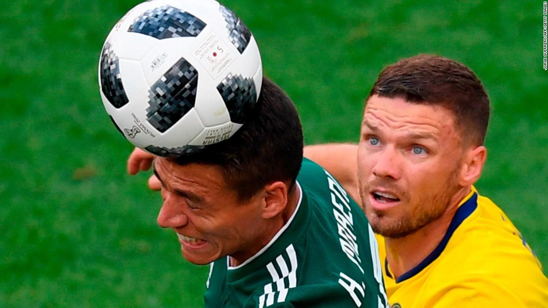 Mexican defender Hector Moreno heads the ball in front of Swedish forward Marcus Berg.