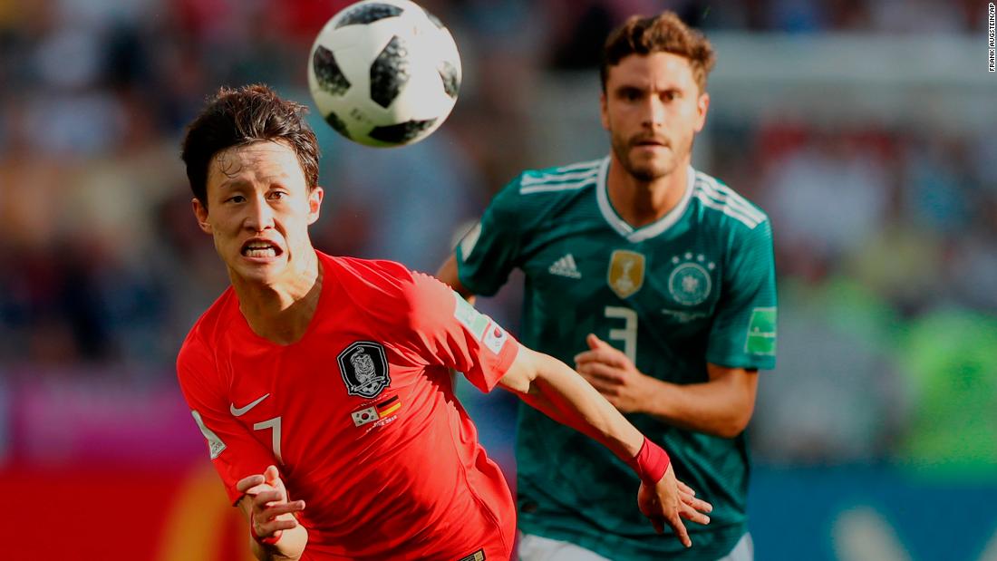 South Korea&#39;s Lee Jae-sung, left, chases down a ball with Germany&#39;s Jonas Hector.