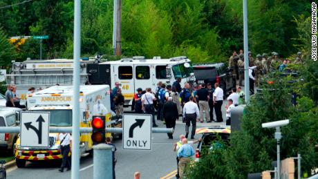 Authorities stage at the building entrance after multiple people were shot at The Capital Gazette newspaper in Annapolis, Md., Thursday, June 28, 2018. (AP Photo/Jose Luis Magana)