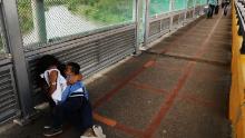 BROWNSVILLE, TX - JUNE 22:  A crying  Honduran woman and her child wait along the border bridge after being denied into the Texas city of Brownsville which has become dependent on the daily crossing into and out of Mexico on June 22, 2018 in Brownsville, Texas. Immigration has once again been put in the spotlight as Democrats and Republicans spar over the detention of children and families seeking asylum at the border. Before President Donald Trump signed an executive order Wednesday that halts the practice of separating families who were seeking asylum, over 2,300 immigrant children had been separated from their parents in the  zero-tolerance policy for border crossers.  (Photo by Spencer Platt/Getty Images)