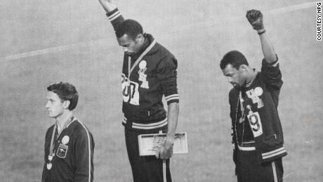 Tommie  Smith  and  John  Carlos raise their fists on the podium at the 1968 Olympics