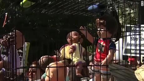 Protesters in Atlanta are carrying a dog crate with baby dolls inside