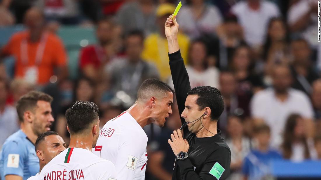 Portugal&#39;s Cristiano Ronaldo receives a yellow card from referee Cesar Ramos near the end of the match.