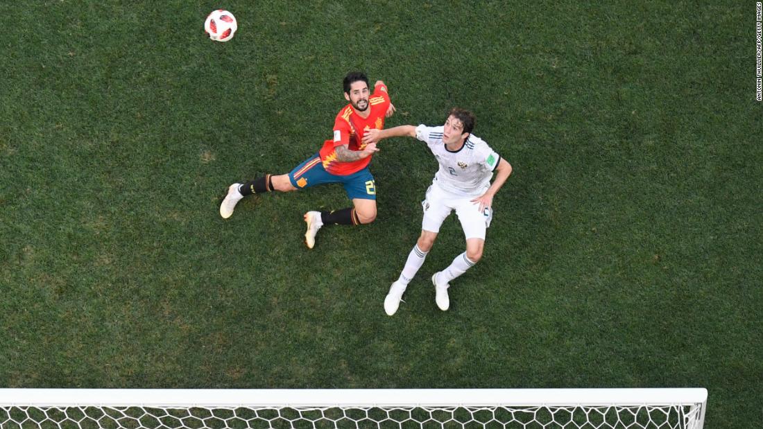 Spain&#39;s Isco and Russia&#39;s Mario Fernandes vie for the ball.