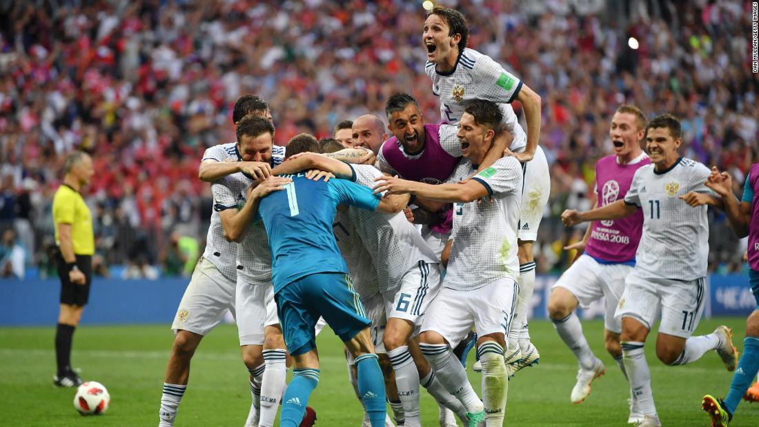 Russian players mob Akinfeev after the final save.