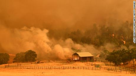 Inmate firefighters work as flames from the County Fire climb a hillside in Guinda, California, on July 1, 2018. - Californian authorities have issued red flag weather warnings and mandatory evacuation orders after a series of wildfires fanned by high winds and hot temperatures ripped through thousands of acres. The latest blaze, the County Fire sparked in Yolo County on June 30, had by July 1 afternoon spread across 22,000 acres (9,000 hectares) with zero percent containment, according to Cal Fire. (Photo by JOSH EDELSON / AFP)        (Photo credit should read JOSH EDELSON/AFP/Getty Images)