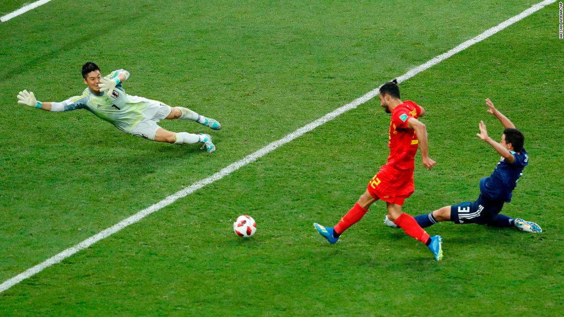 Chadli slides the ball past Japan goalkeeper Eiji Kawashima to finish off Belgium&#39;s 3-2 comeback victory. It is the first time since 1970 that a team has come back from two goals down to win in the World Cup knockout stage. 