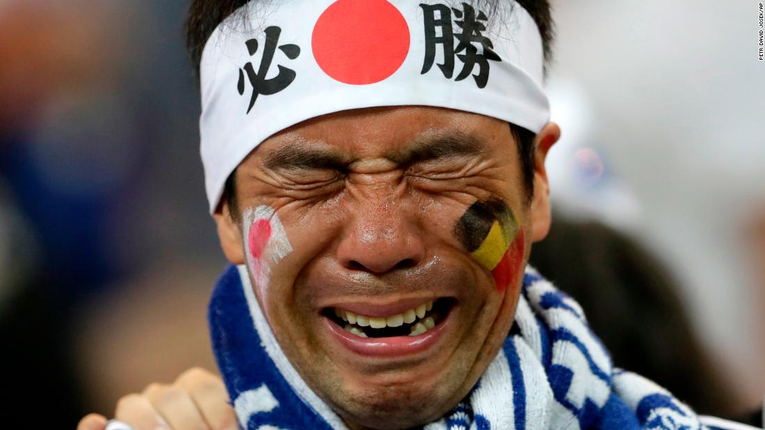A Japan supporter cries after the match.
