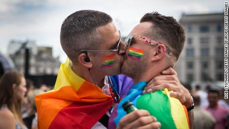 A couple kiss during London&#39;s annual Pride Parade, which has been canceled this year due to the coronavirus pandemic.