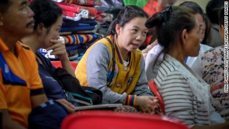 Family members of the stranded children and their coach gather at Khun Nam Nang Non Forest Park to hear updated news on the rescuse efforts, Tuesday morning. 