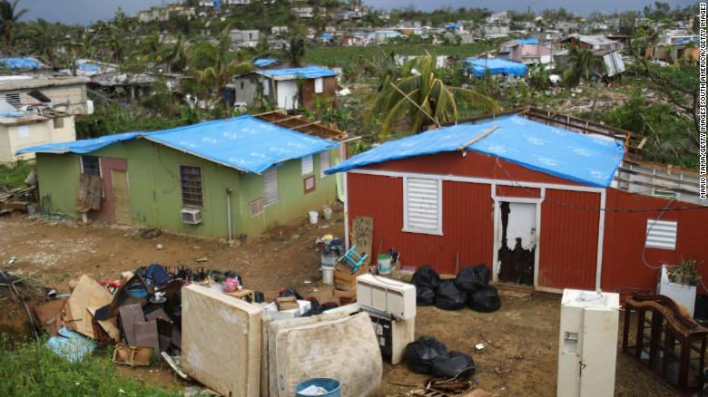 SAN ISIDRO, PUERTO RICO - OCTOBER 15:  Uncollected debris stand near damaged homes in an area without electricity on October 15, 2017 in San Isidro, Puerto Rico. Puerto Rico is suffering shortages of food and water in many areas and only 15 percent of grid electricity has been restored. Puerto Rico experienced widespread damage including most of the electrical, gas and water grid as well as agriculture after Hurricane Maria, a category 4 hurricane, swept through.  (Photo by Mario Tama/Getty Images)