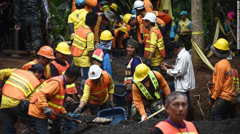 Workers fix the road leading to the Tham Luang Nang Non cave system after the team was found alive. 