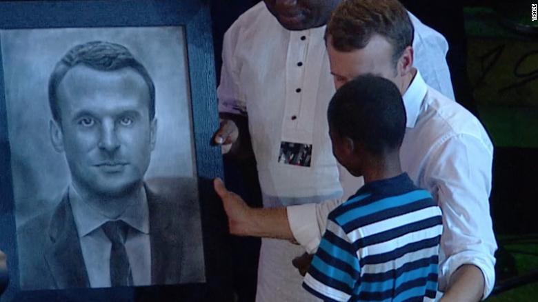 11-year old Nigerian hyperrealist artist, Kareem Olamilekan draws portrait of French President&#39;s Macron at the African shrine on July 3, 2018.