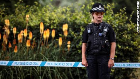 A police officer stands Wednesday by a cordon at Queen Elizabeth Gardens in Salisbury, another site the couple is thought to have visited.