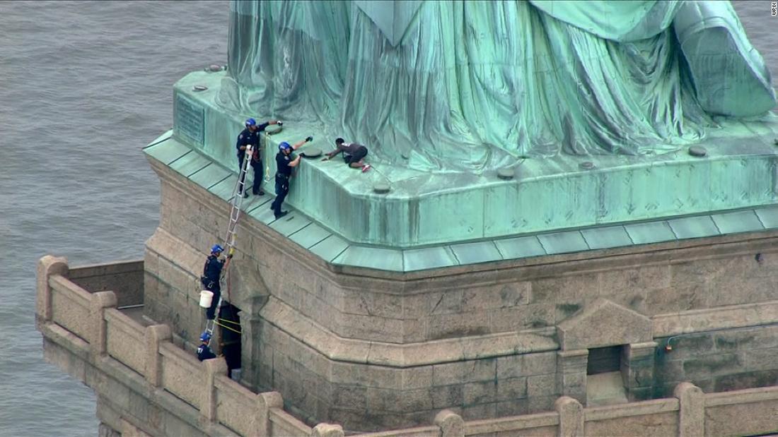 Woman Climbs Base Of The Statue Of Liberty Cnn Video