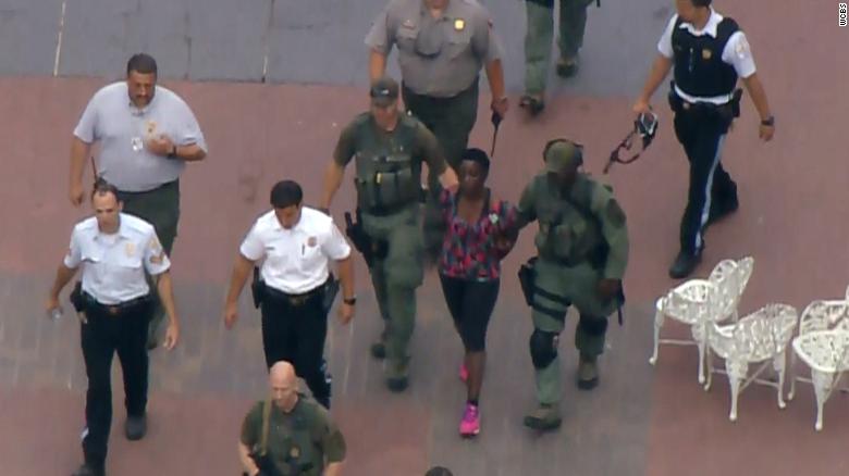 The protester who climbed onto the Statue of Liberty is led away by police on July 4, 2018.