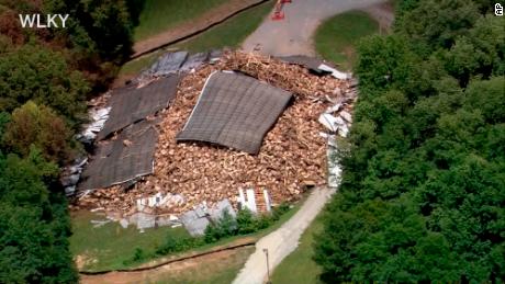 Whiskey barrels are piled in a heap Wednesday, July 4, 2018, after the rest of the Barton 1792 Distillery, a whiskey storage warehouse, collapsed in Bardstown, Kentucky, nearly two weeks after part of the decades-old structure came crashing down. No injuries were reported in either collapse, said Nelson County Emergency Management spokesman Milt Spalding.  (WLKY-TV, CBS Louisville via AP)