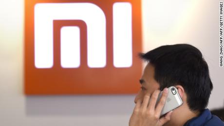 This picture taken on January 7, 2015 shows a man using his mobile phone at a Xiaomi shop in Beijing.    AFP PHOTO / WANG ZHAO / AFP / WANG ZHAO        (Photo credit should read WANG ZHAO/AFP/Getty Images)