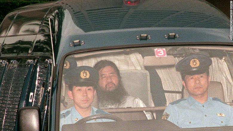 Shoko Asahara, head of the doomsday cult Aum Shinrikyo, is transferred from Tokyo police headquarters to Tokyo District Court for questioning in July 1995.