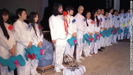 Aum Shinrikyo cult group founder Shoko Asahara (4th from left), whose real name is Chizuo Matsumoto, speaking at a press conference in Tokyo in 1990 to announce a plan to field candidates for the general election. 